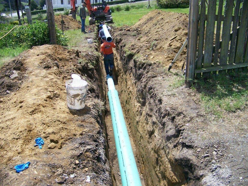 Construction workers laying underground pipelines
